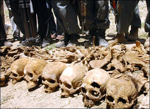 Afghan officials pose near a row of skulls. Pics by Massoud Hossaini